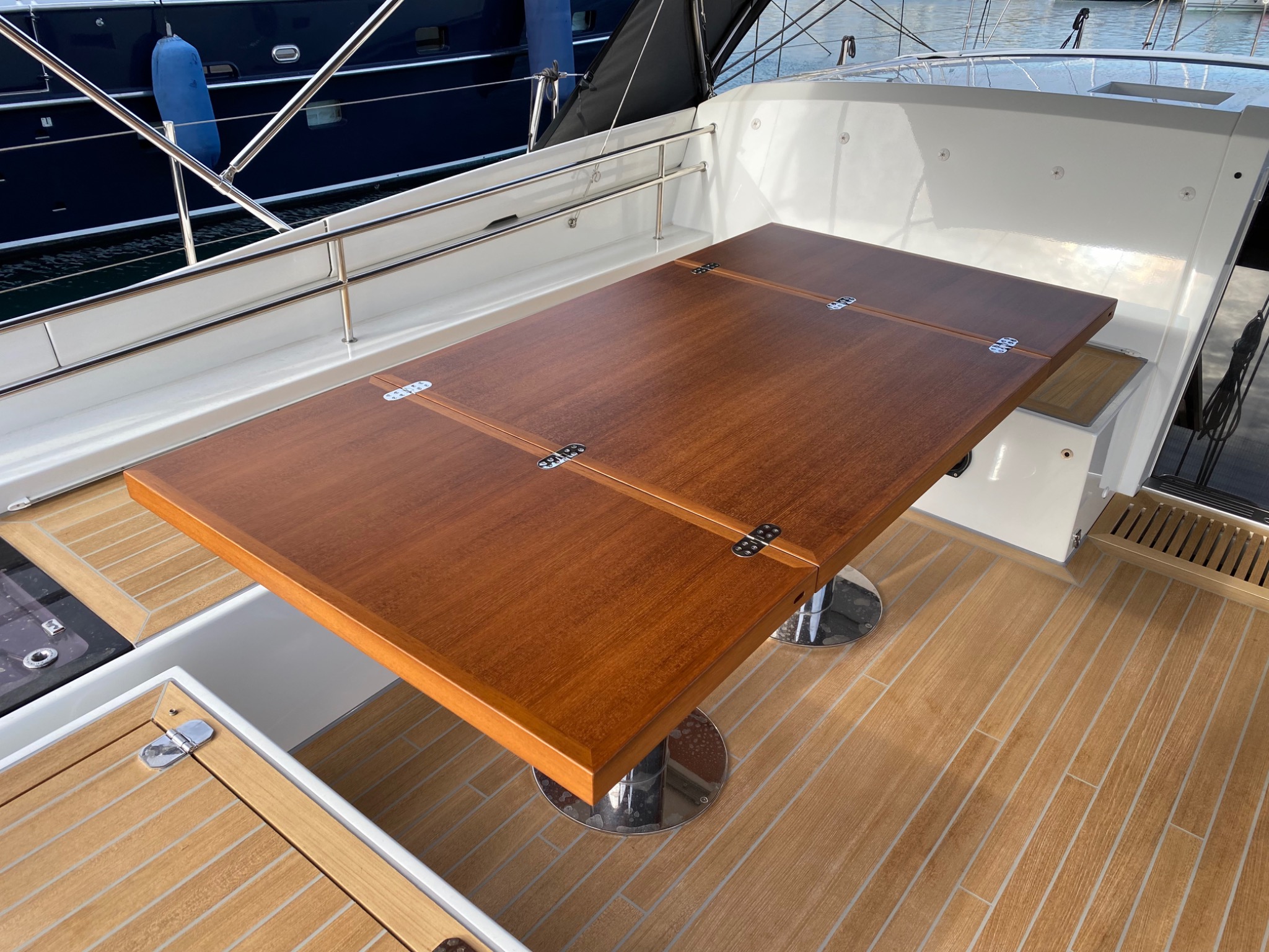 Restored yacht cockpit table opened to its full dining configuration