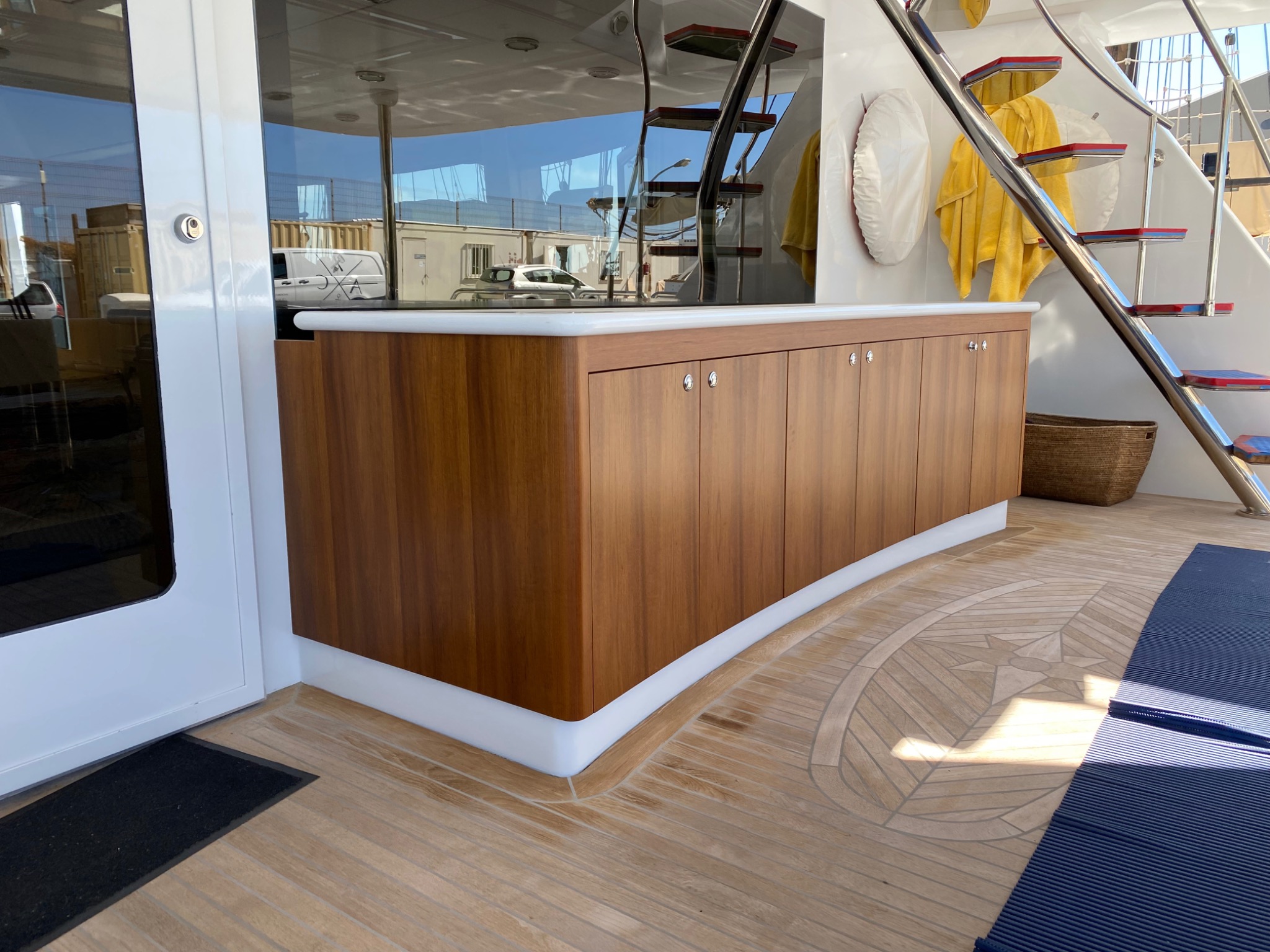 Custom-fabricated timber cabinet installed on a motor yacht aft deck