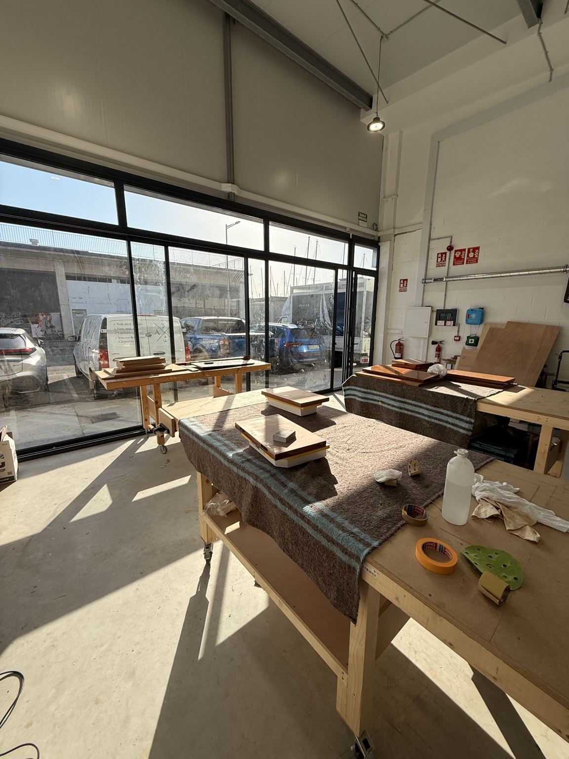 Sunlit worktables inside the Anchored Carpentry workshop