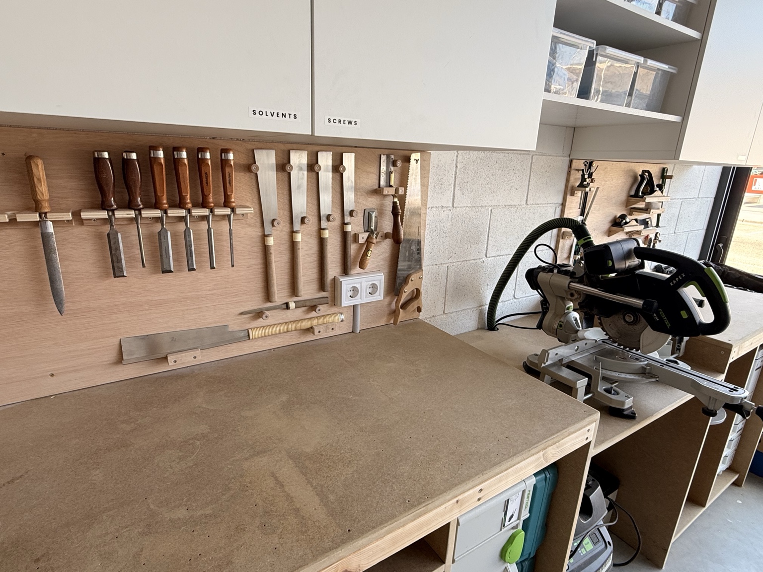 Hand tools and cutting station inside the Anchored Carpentry workshop